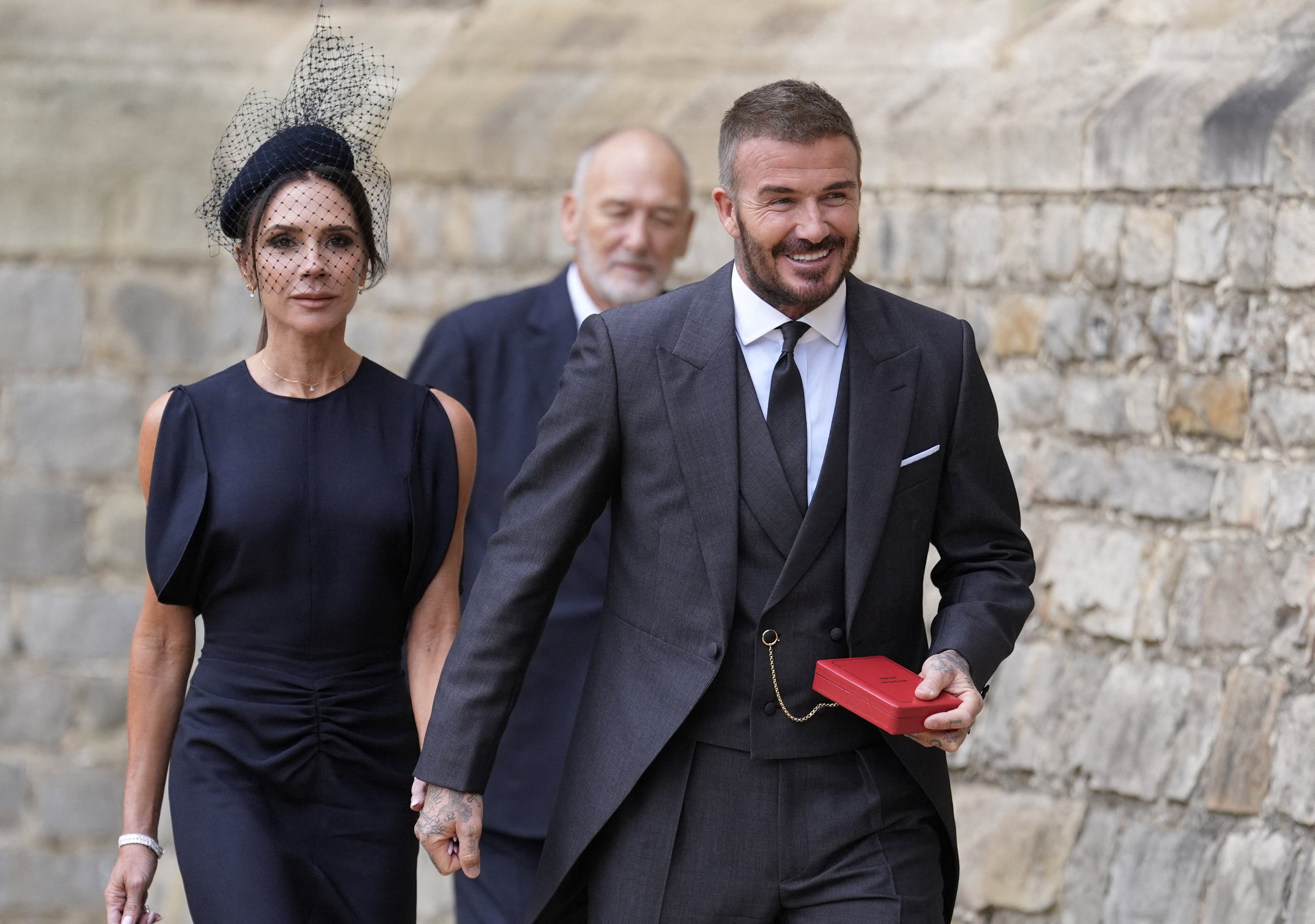 Sir David Beckham, walks with his wife Lady Victoria, after he was made a Knight Bachelor at an investiture ceremony at Windsor Castle, Berkshire. November 4, 2025. Andrew Matthews/Pool via REUTERS