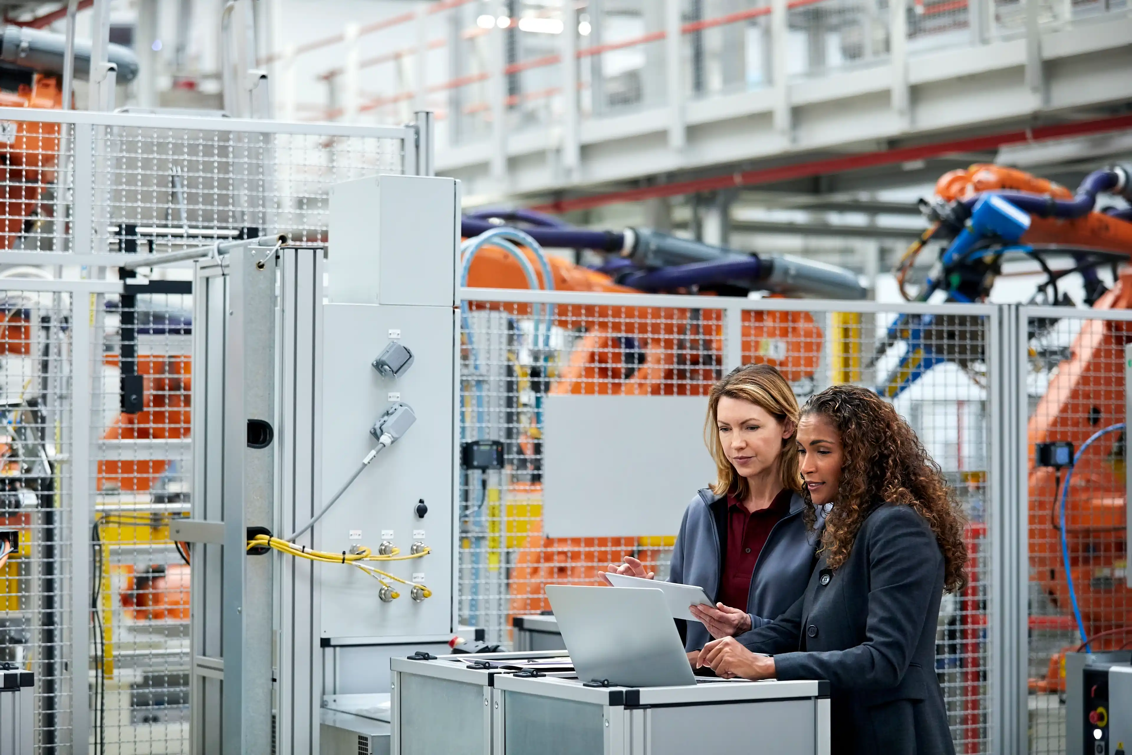 Two people collaborating in a factory