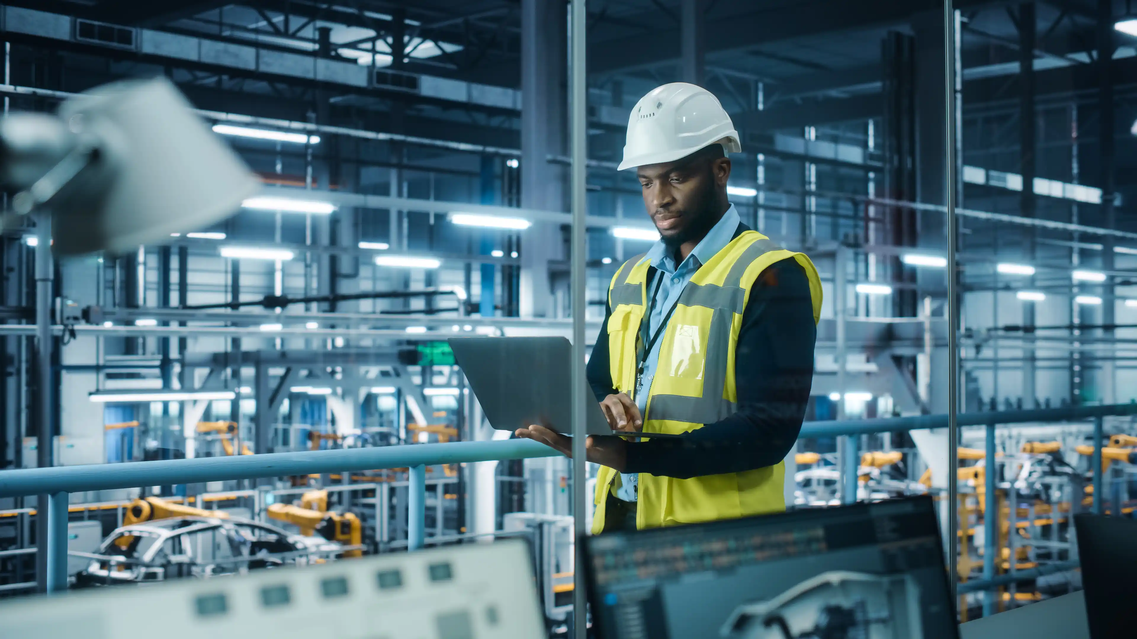 Person with laptop in factory