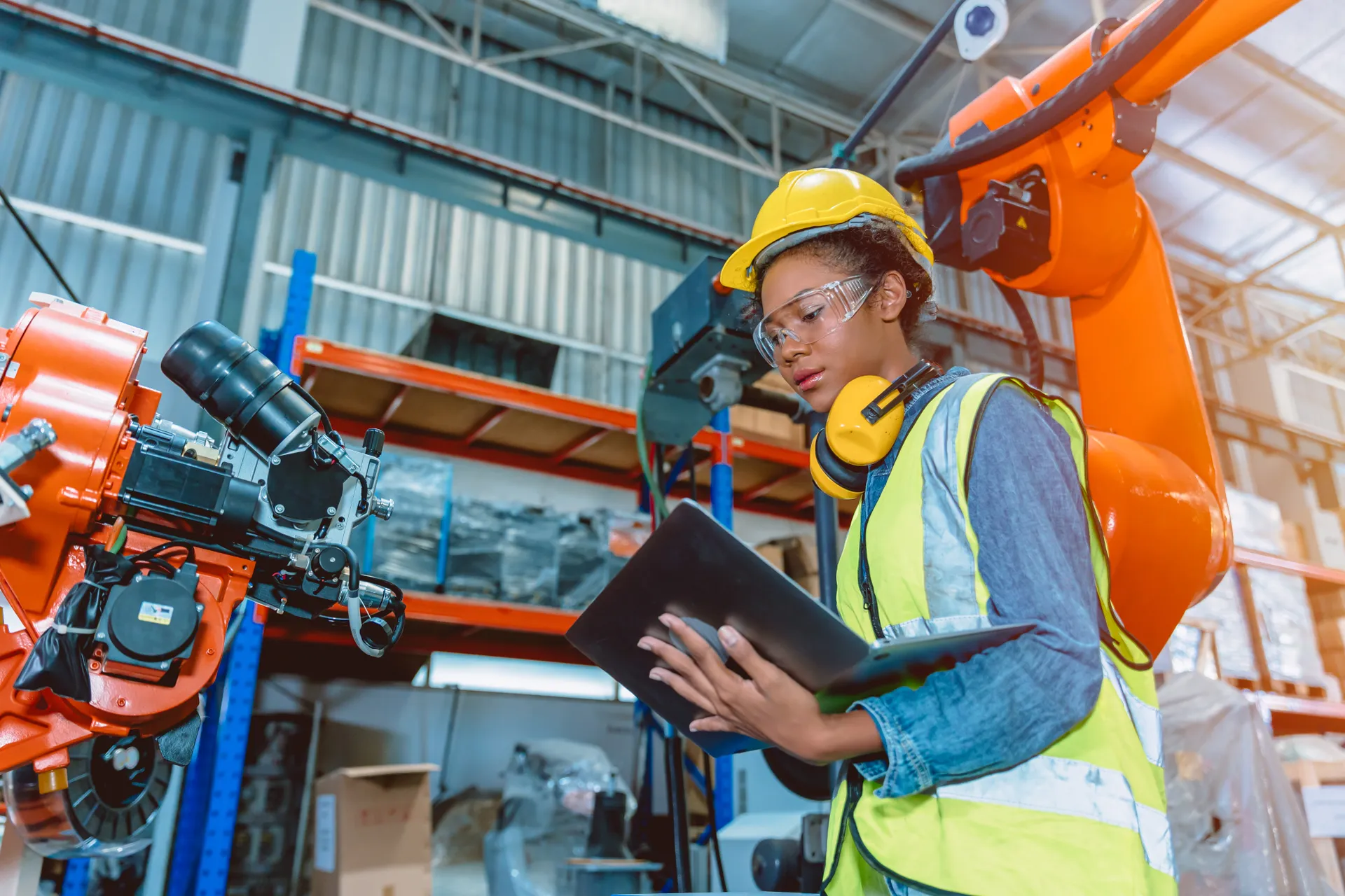 Person using laptop in a warehouse