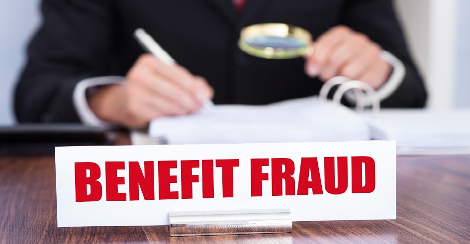 Desktop sign that says benefit fraud