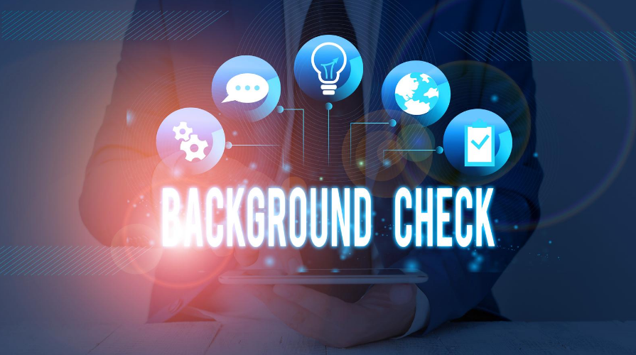 Background Check text with icons in the foreground and a man using a table in the background