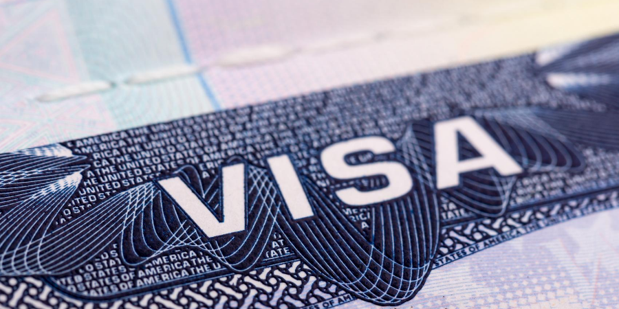 Image with the word visa in white text on a blue background with the words The United States of America in smaller text on the background