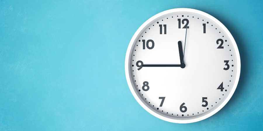 White wall clock on blue background