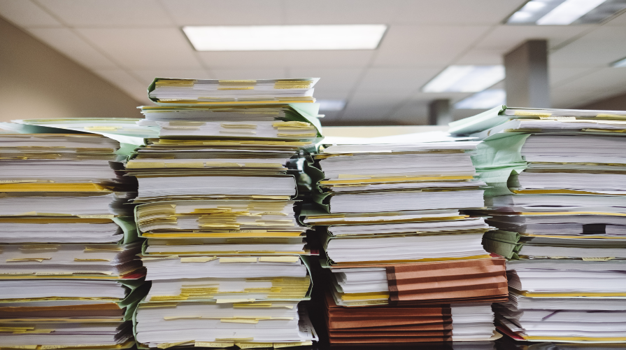 photo of stacks of files, folders, documents in an office