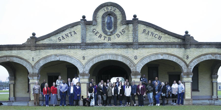 While visiting the King Ranch, members of the LTASB Class of 2024 pose for a photo outside the historic Santa Getrudis Ranch building.