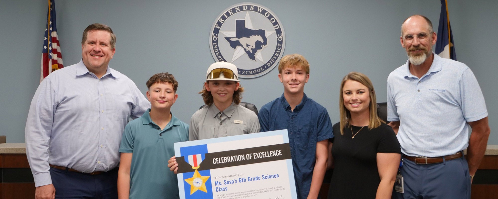TASB President Tony Hopkins (left) and Friendswood ISD Superintendent Thad Roher (right) honor sixth-grade students and their science teacher, Brittni Sosa, at a school board meeting for their innovation and dedication to learning. 

Photo courtesy of Friendswood ISD 