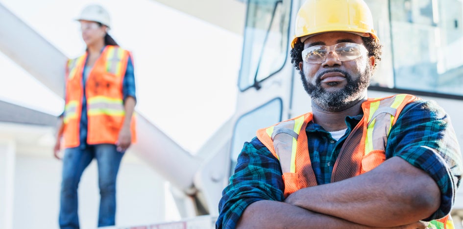 two construction workers in proper safety equipment 