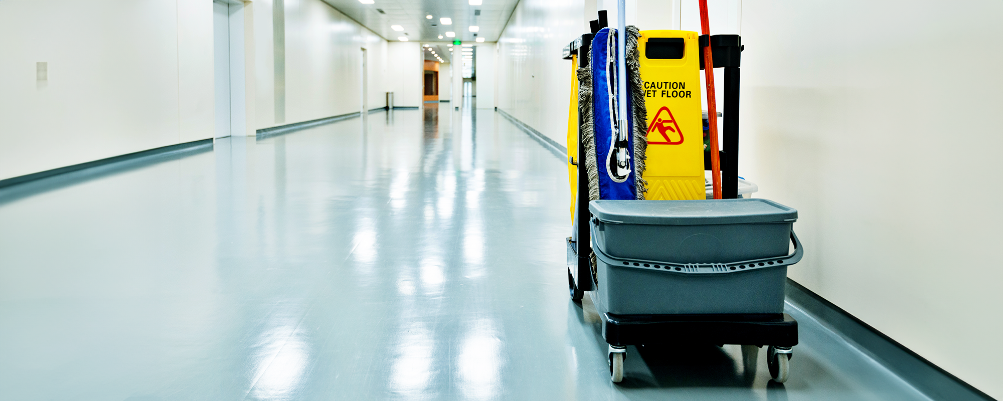 photo of a cleaning cart in an empty hallway (banner image)