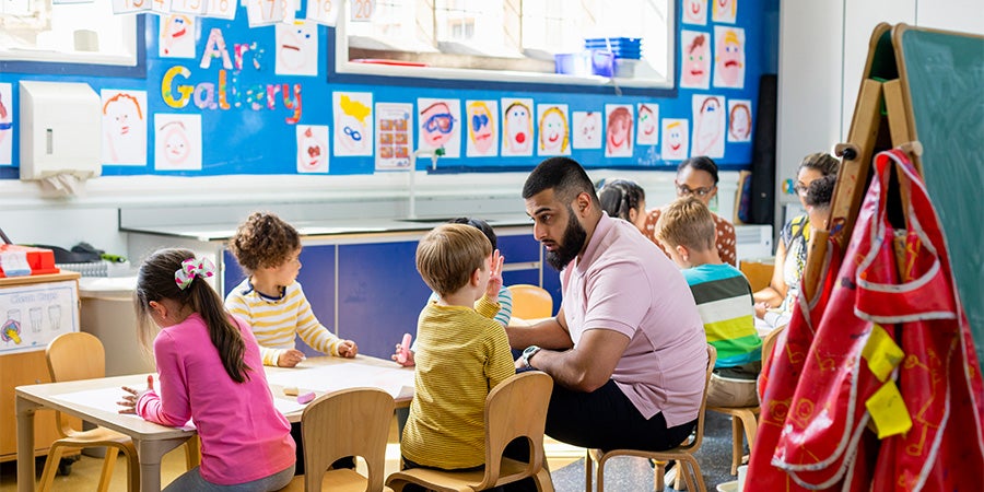 Teacher interacting with kindergarten students