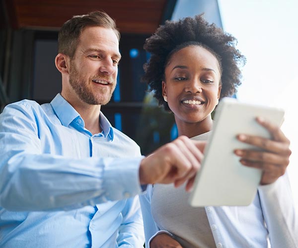 Two colleagues looking at tablet device