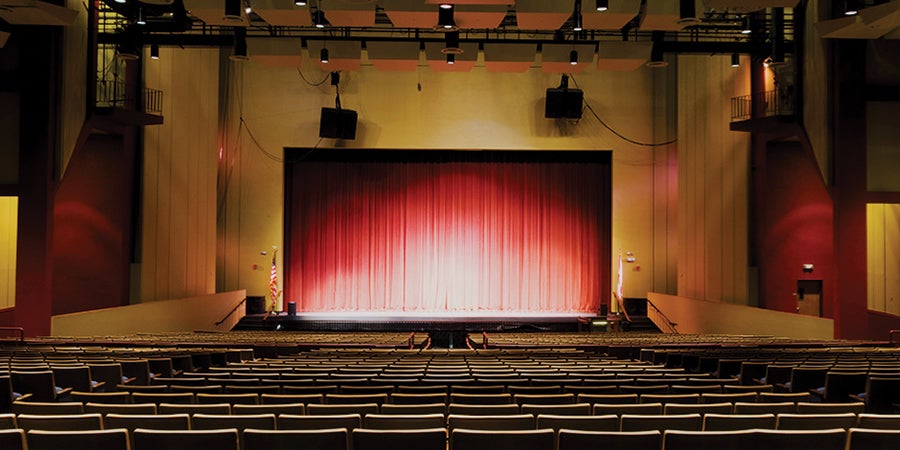Empty student theater center with stage lights on