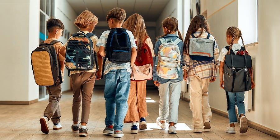 Children walking in a school hallway 