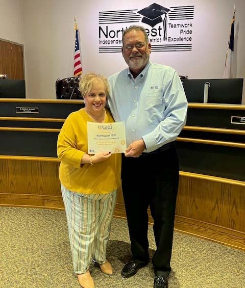 TASB Risk Management Marketing Consultant Scot Parnell presents a Fund Excellence Award to Northwest ISD Executive Director of Benefits and Risk Management Kitty Poehler.