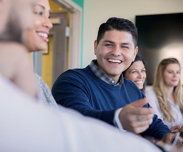 Smiling man attending meeting