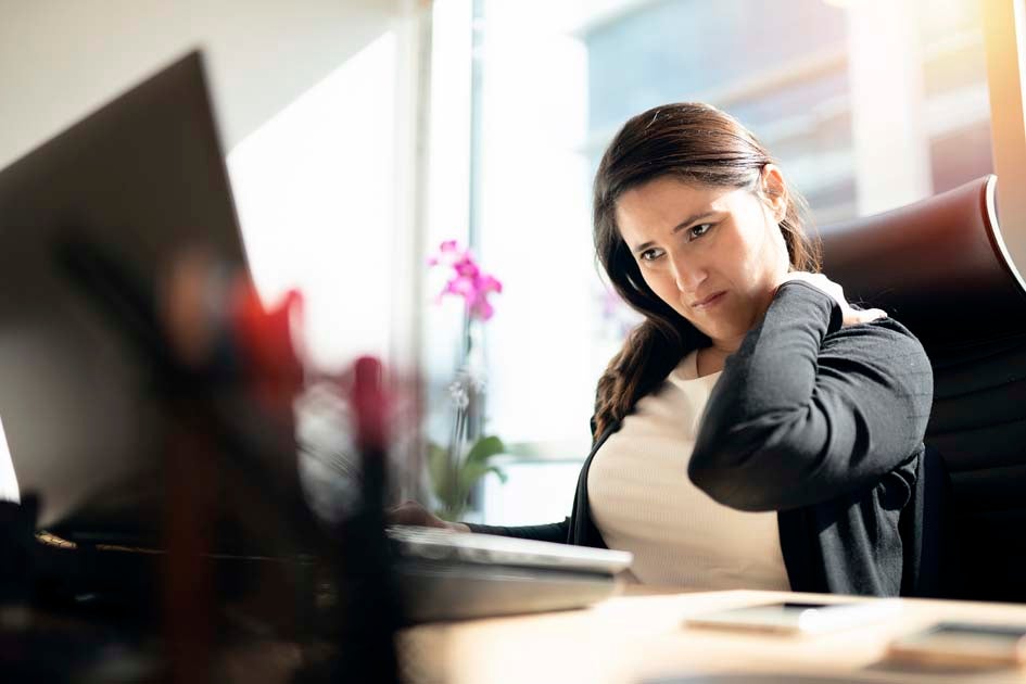 Woman with neck pain at computer