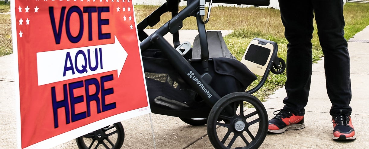 Vote here sign next to a stroller
