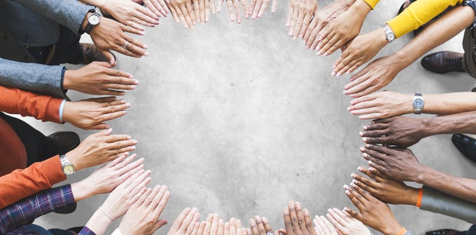 group of people with both hands extended forming a circle 