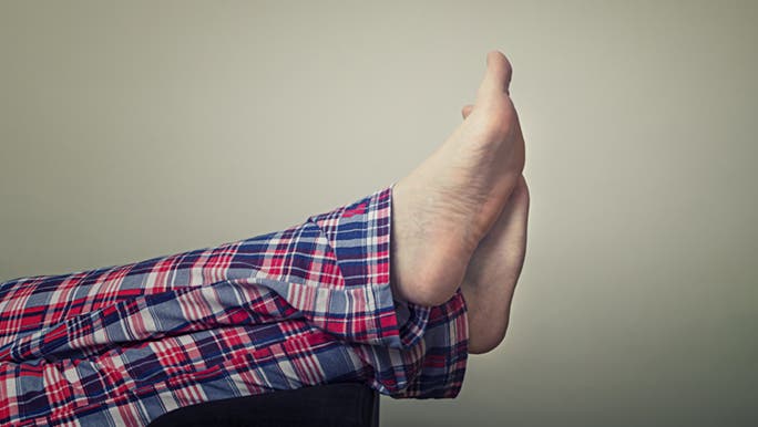 Beneath a pair of flannel pyjamas are a pair of bare feet. Their owner wants to know how to reduce the odour of smelly feet.