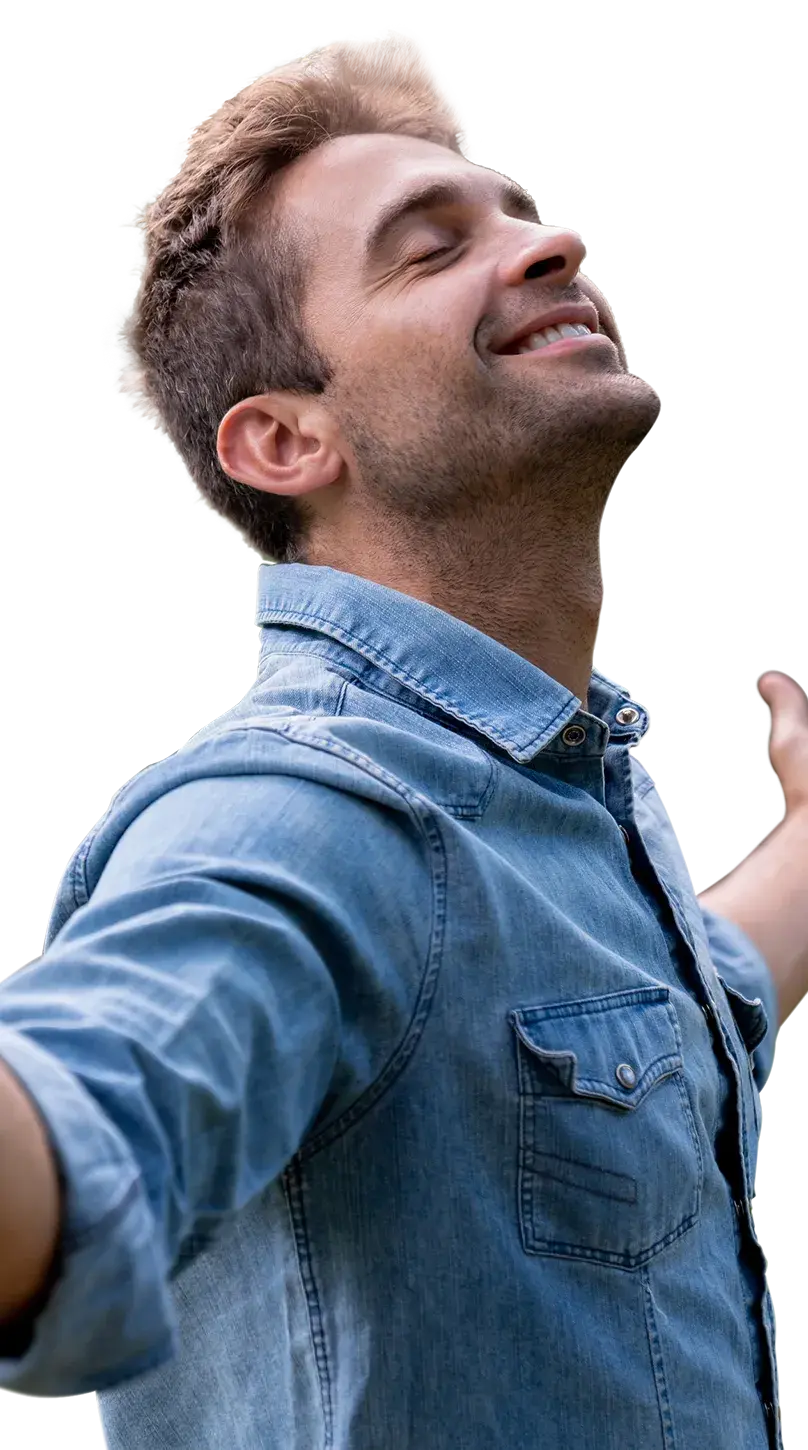 Smiling man with eyes closed and arms raised out enjoying the sun