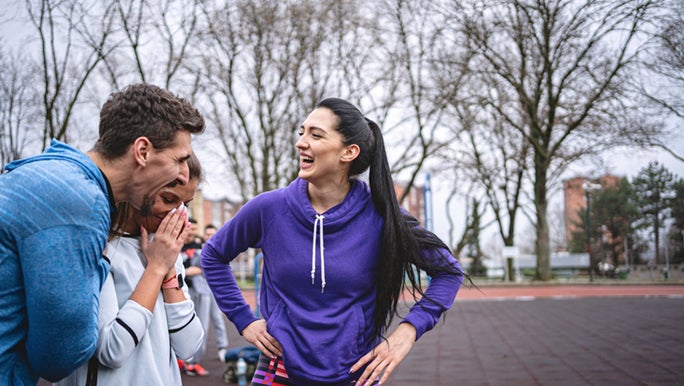 There’s 3 friends outside, laughing after a workout they all did together. Perhaps moving your body boosts energy when you’re tired and cold.
