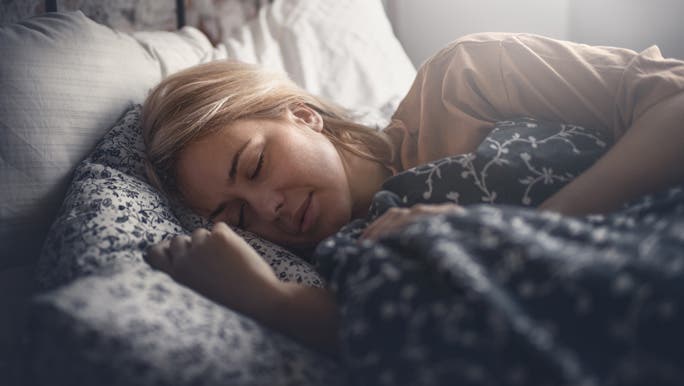 Woman sleeping peacefully in bed