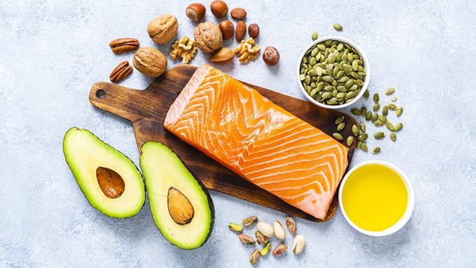 On a marble bench and wooden board, an array of good mood food is displayed.