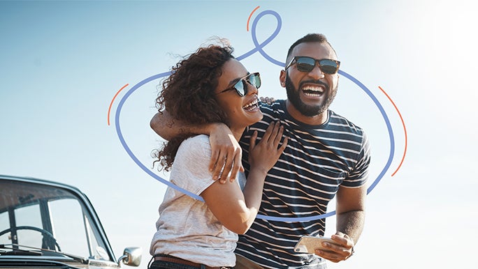 Young couple outdoors laughing and smiling