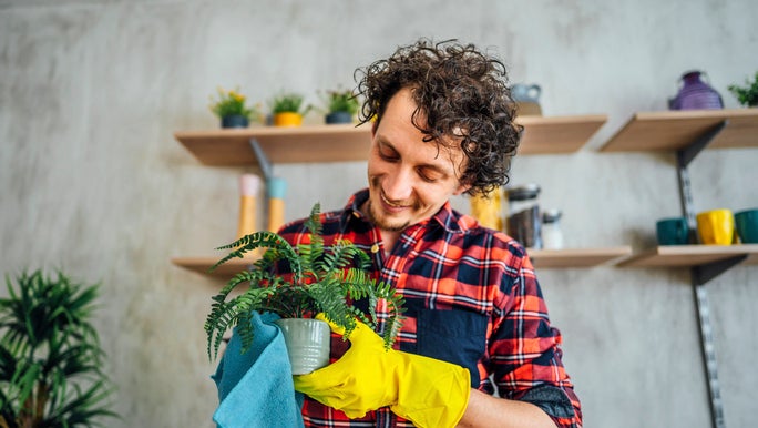 man-smiling-at-plant.jpg