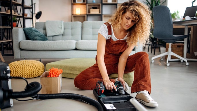 HEA - woman-holding-vacuum-cleaner.jpg