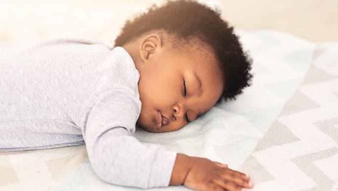 A baby rests peacefully and enjoys the benefits of napping. 