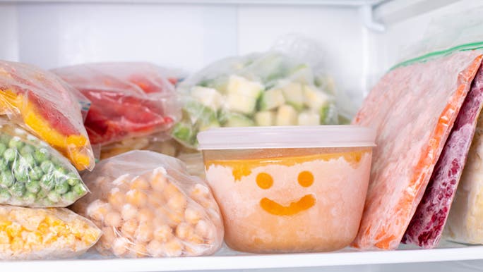 A stack of frozen vegetables in the freezer are considered to be processed food making it hard to choose fresh vs processed foods.