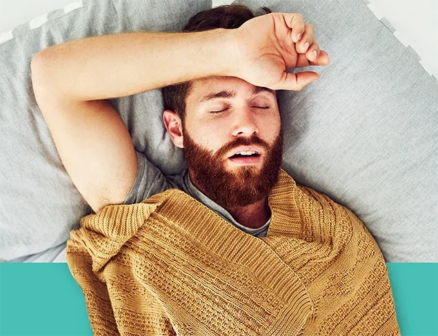 middle aged man asleep in bed