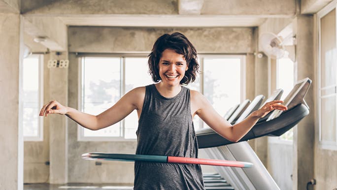 Laughing while hula hooping, a woman has discovered one of the fun ways to exercise by yourself.