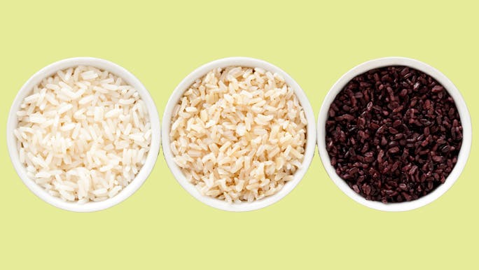 Three bowls of rice - white rice, brown rice and black rice