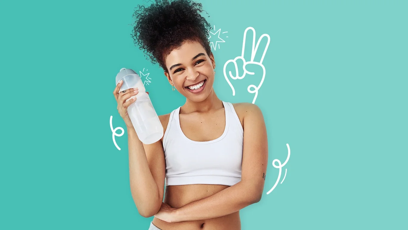 Smiling young woman in a white crop top holding a reusable water bottle