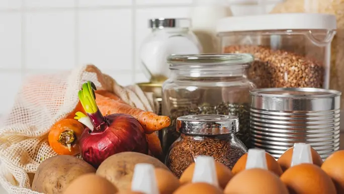 Food supplies in abundance at home on the table including eggs, lentils and grains