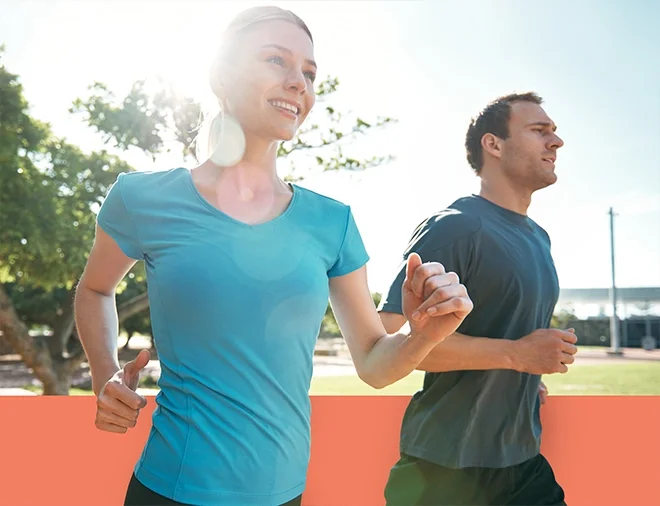 happy couple running at the park in sun