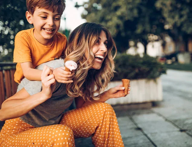 Happy mum and her son out eating ice cream for a treat