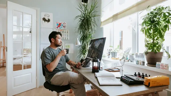Man working from home during self isolation and having a coffee break