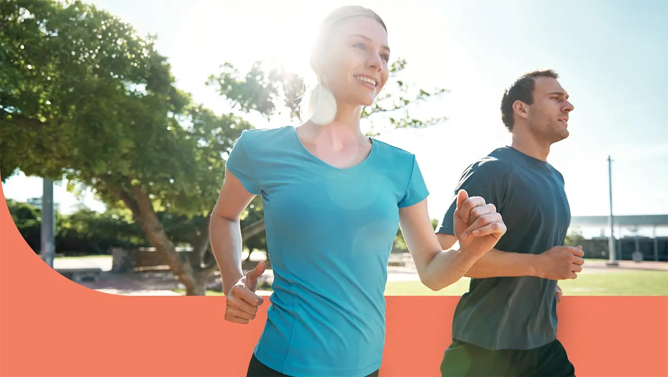 Couple smiling and running on a sunny day