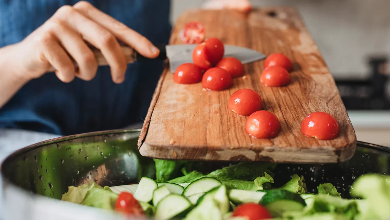 salad-being-chopped-into-bowl.webp