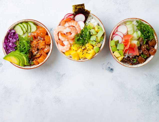 Three protein rich poke bowls with salmon, prawns, tuna, rice and fresh vegetables