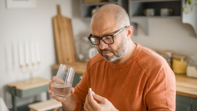 man-taking-probiotic-pill.jpg