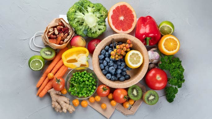 Vitamin C foods including berries, tomatoes, parsley, peas, broccoli, citrus and kiwifruit