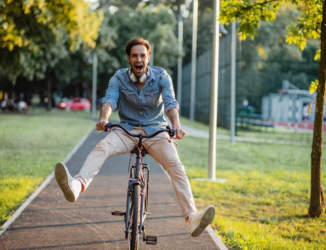 Energetic man riding his bike in the park
