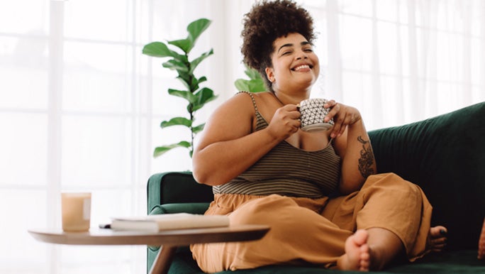 woman-drinking-coffee-whilst-smiling.jpg