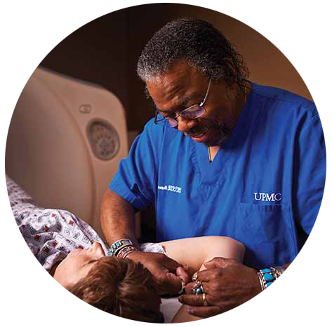 R.T. in blue scrubs with a CT patient - circle image with a transparent background