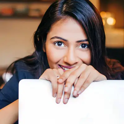 woman leader looking over her laptop?fm=webp&q=65