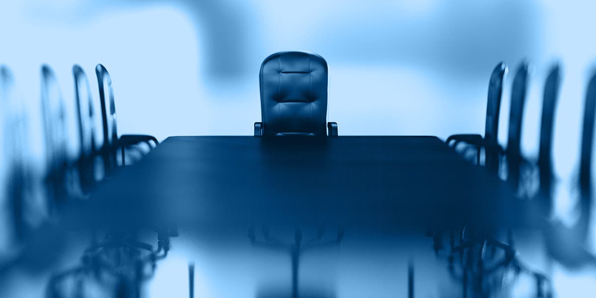 Empty seats around a board room table to depict the danger of boards that don't perform CEO succession planning